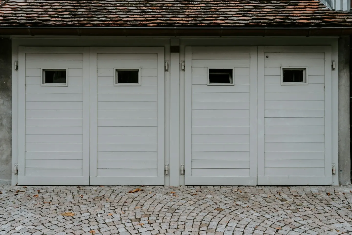 Residential garage exterior used as a contextual opener-repair image
